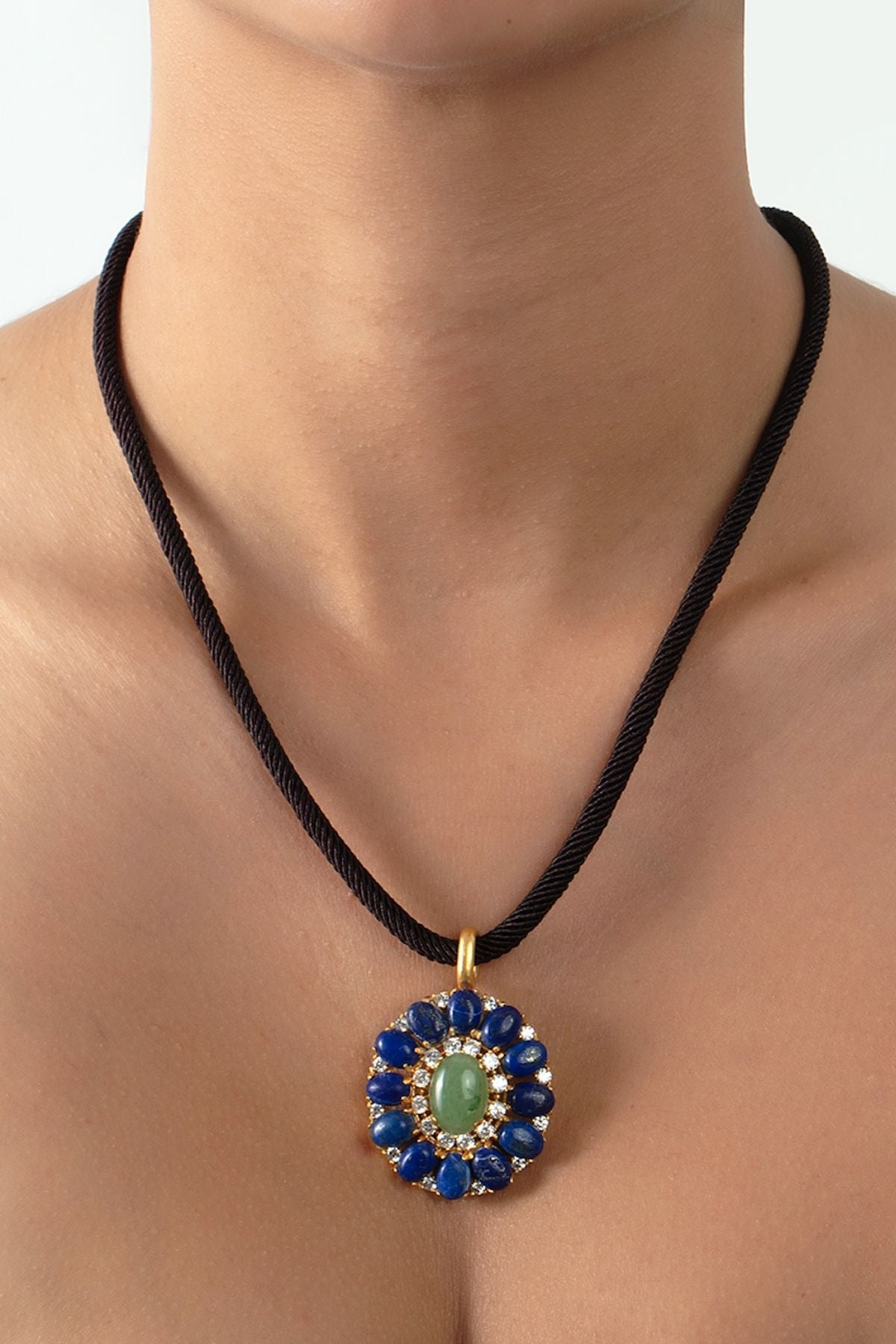 Necklace with a decorative pendant featuring blue and green stones on a plain background