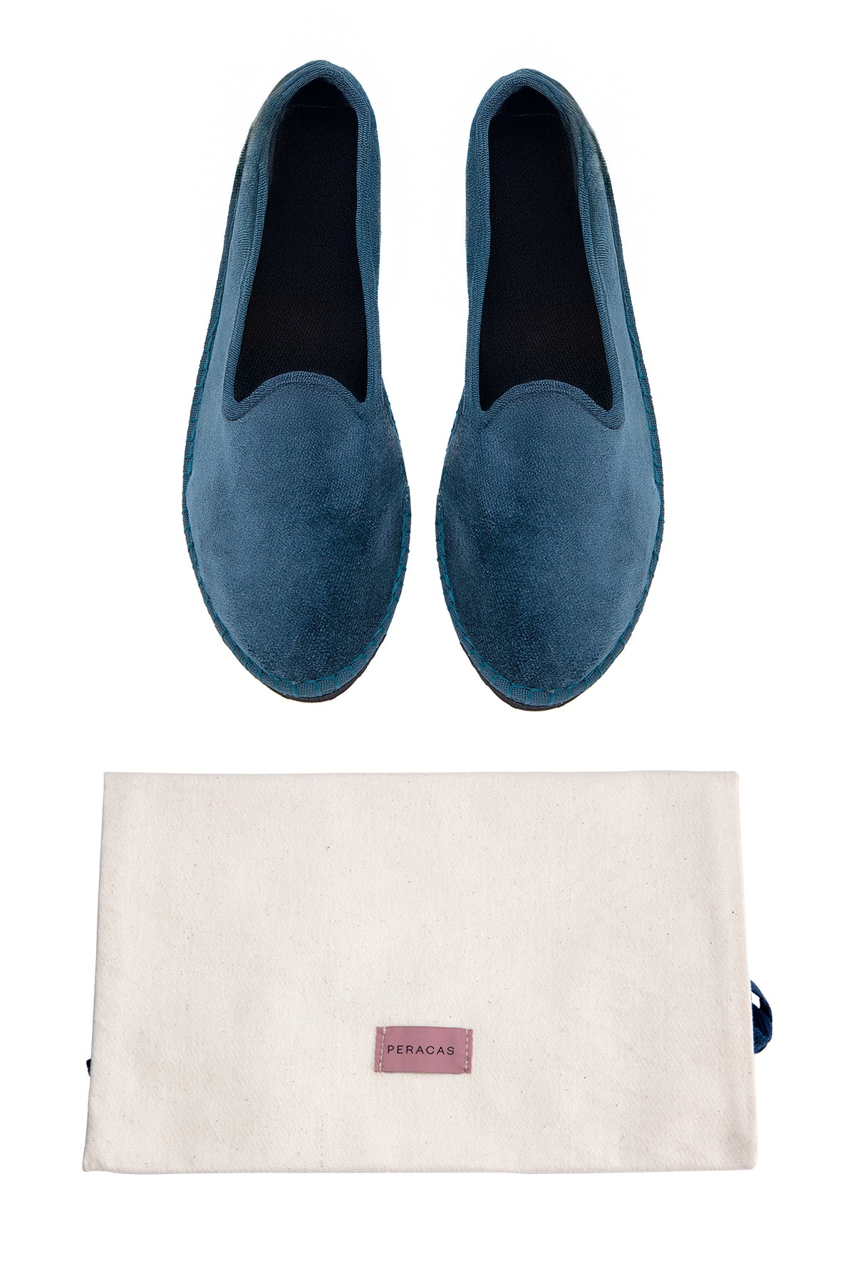 Pair of blue loafers with a matching pouch on a white background