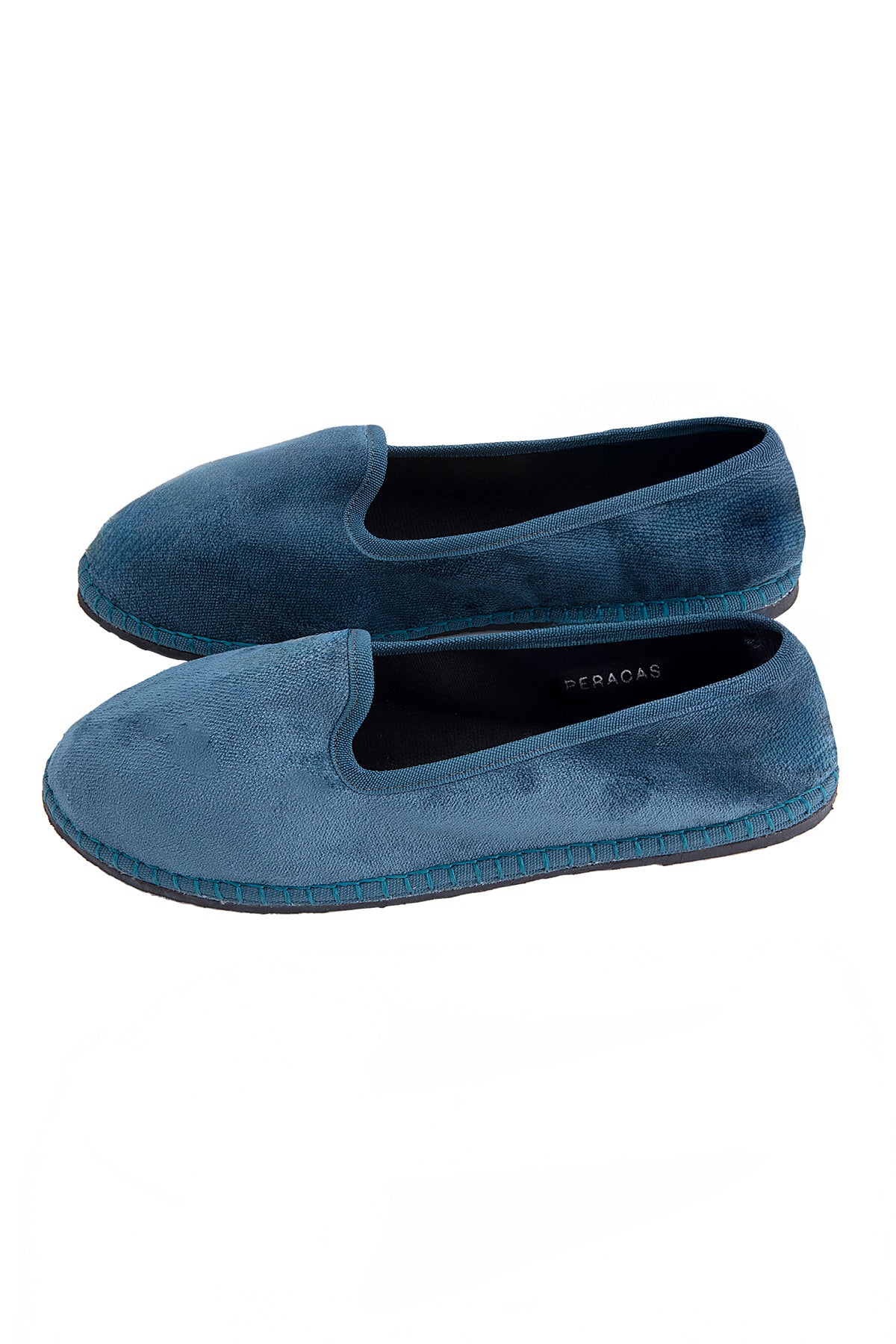 Pair of blue loafers on a white background