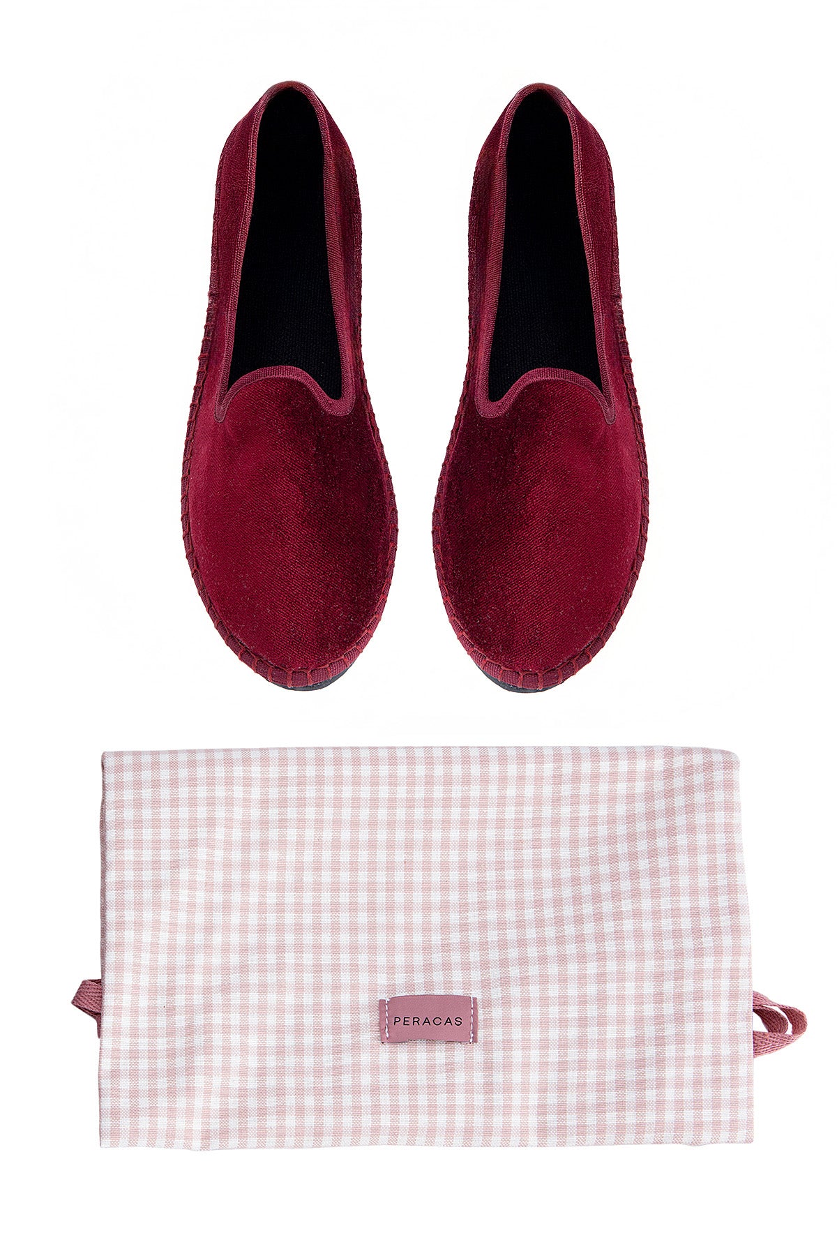 Pair of red slippers with a matching gingham-patterned pouch on a white background