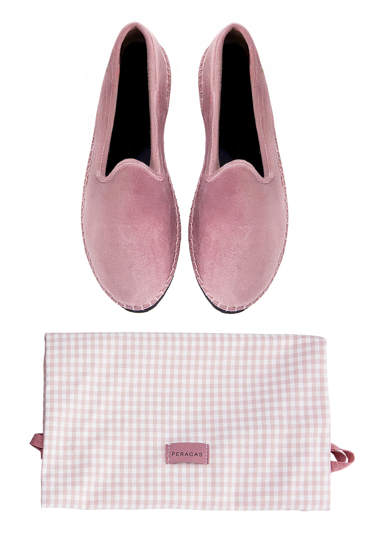 Pair of pink velvet slippers with a matching pouch on a white background