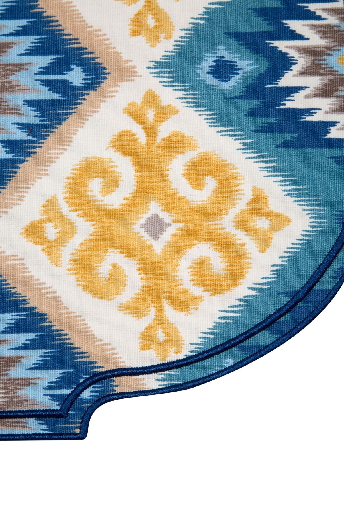 Close-up of a patterned rug with blue, yellow, and beige colors.