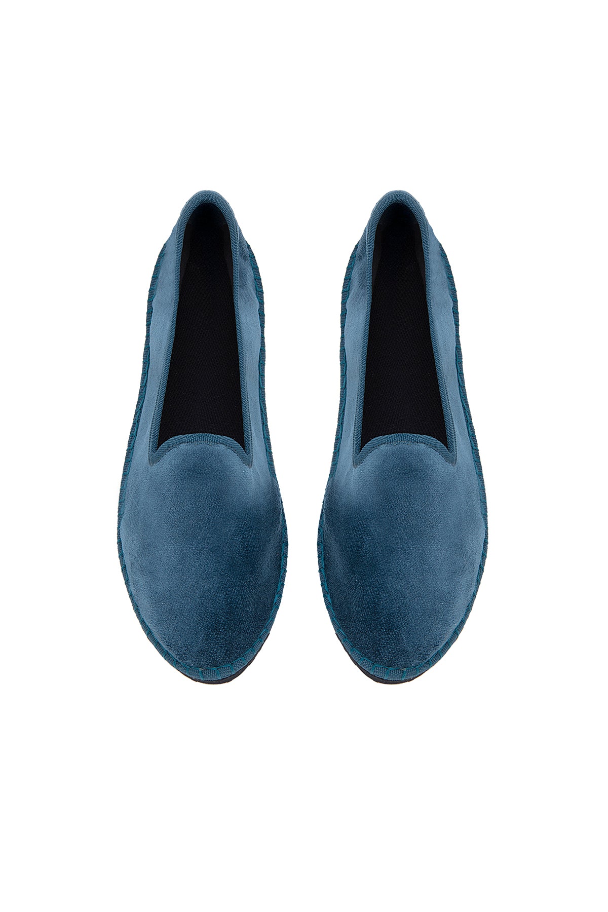 Pair of blue loafers on a white background