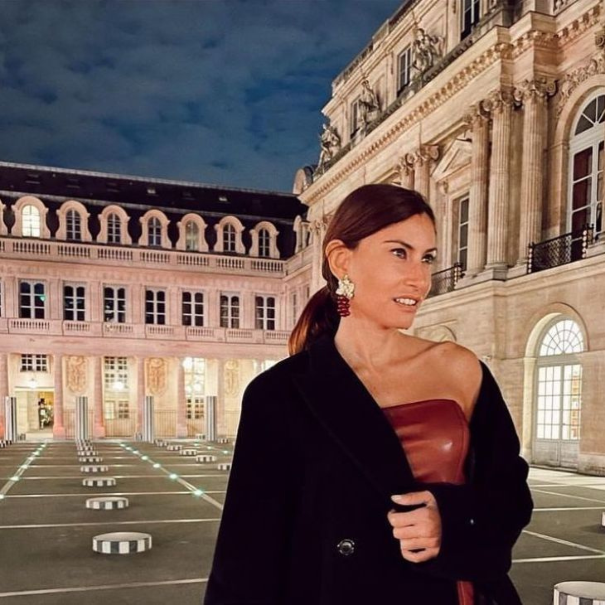 Woman standing in front of a grand building with classical architecture