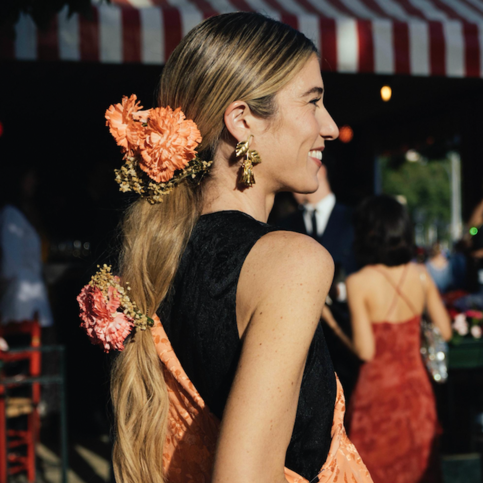 Woman with floral hair accessories at an outdoor event