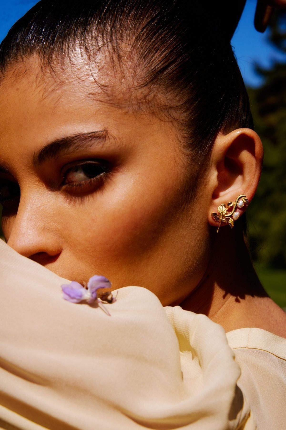 Close-up of a woman wearing earrings with a blurred background